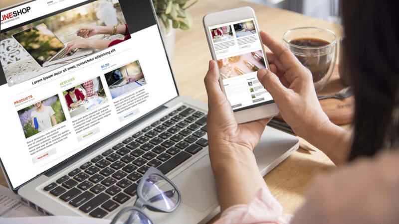 Woman using several digital devices