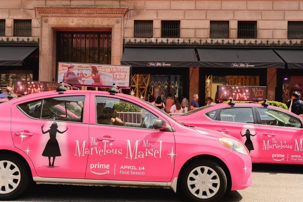 Two pink taxis branded sit outside Saks Fifth Avenue in New York as part of a branded effort by Amazon Prime Video promoting its