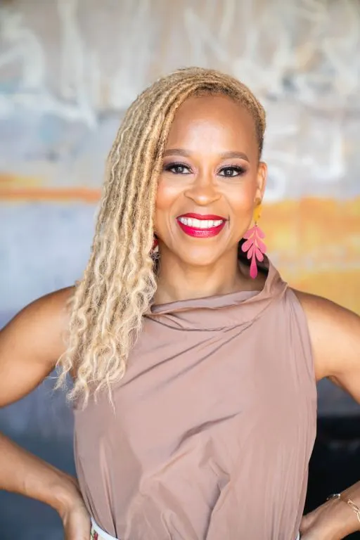 Unilever Chief Growth and Marketing Officer Esi Eggelston Bracey wears a cream-colored dress in a headshot photo